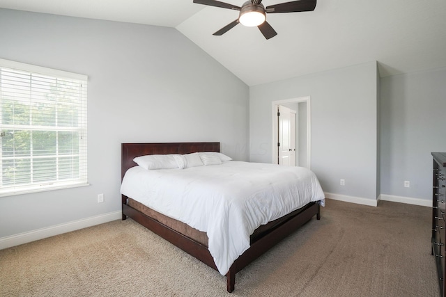 carpeted bedroom featuring ceiling fan, multiple windows, and lofted ceiling