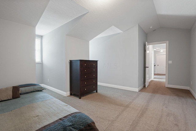 carpeted bedroom with vaulted ceiling