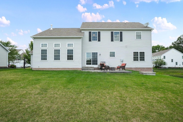 back of house featuring a patio area and a yard