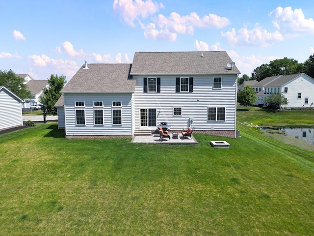 rear view of property featuring a yard and a patio