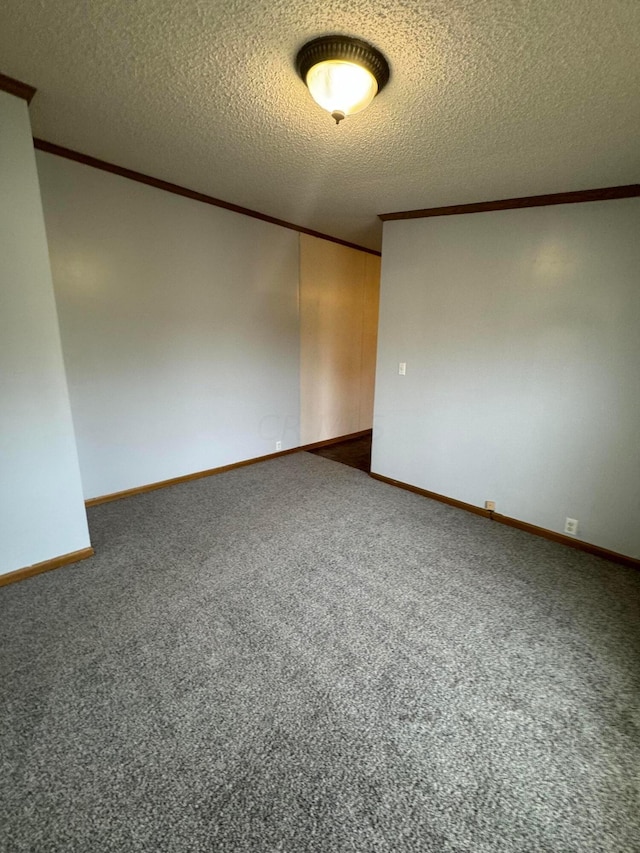 carpeted spare room featuring a textured ceiling