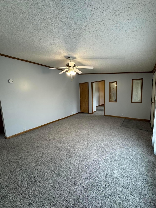 spare room with carpet flooring, a textured ceiling, and ceiling fan