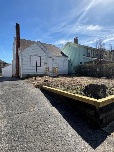 rear view of house with an outbuilding and a garage