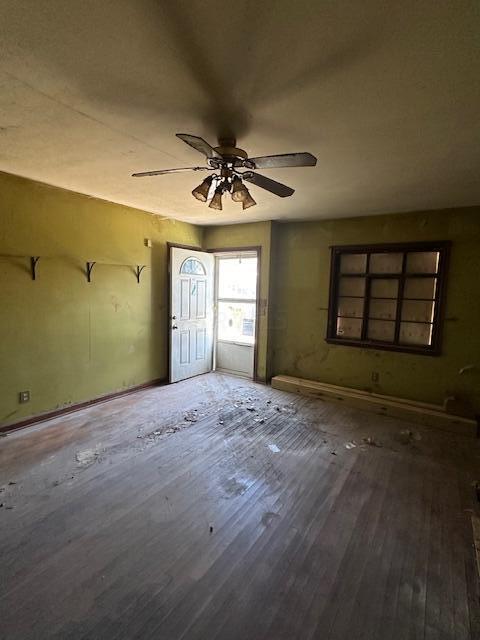 unfurnished room featuring hardwood / wood-style flooring and ceiling fan