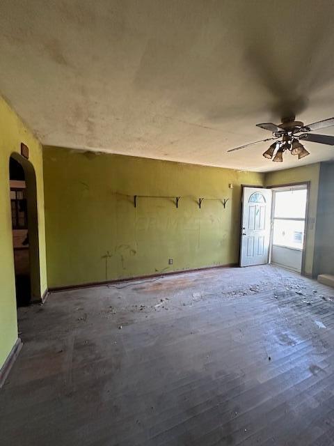 spare room with ceiling fan and dark wood-type flooring