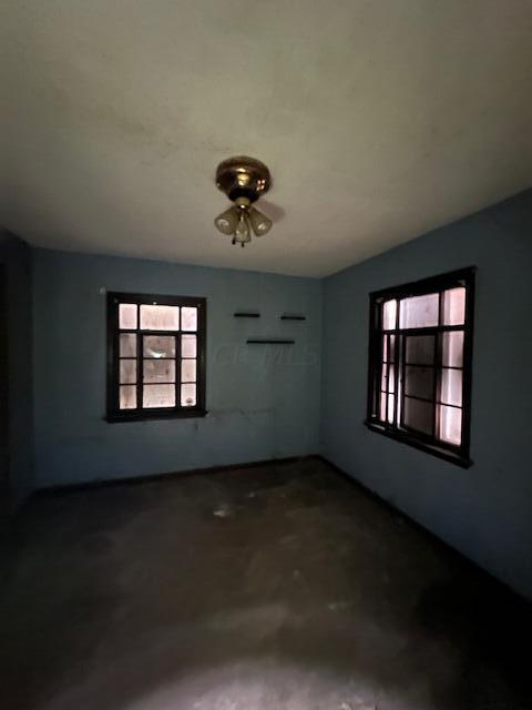 spare room featuring concrete flooring