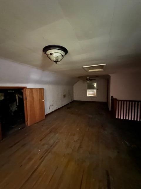 additional living space featuring dark hardwood / wood-style flooring and lofted ceiling