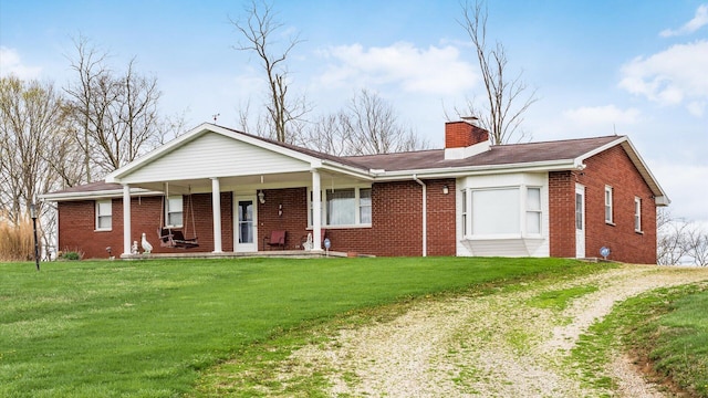 ranch-style house with covered porch and a front yard