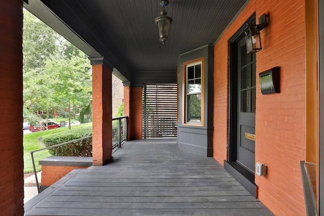 wooden terrace featuring covered porch