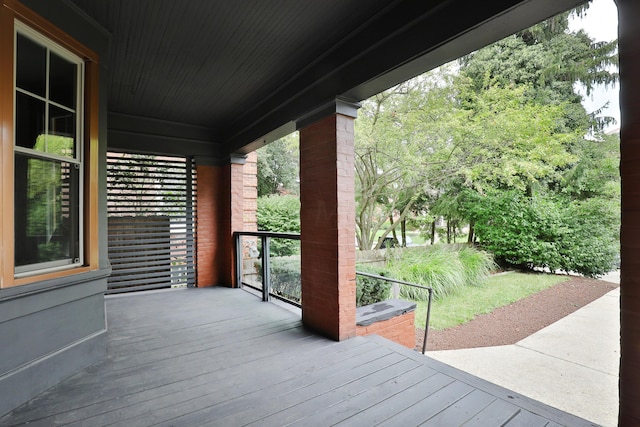 wooden terrace featuring covered porch