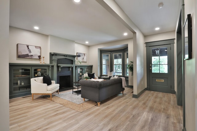 living room featuring a fireplace and light hardwood / wood-style flooring