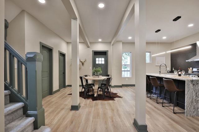 dining space with light hardwood / wood-style floors and sink