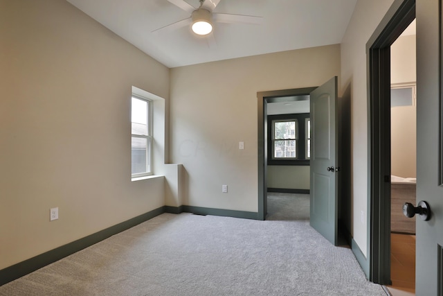 unfurnished bedroom featuring carpet and ceiling fan