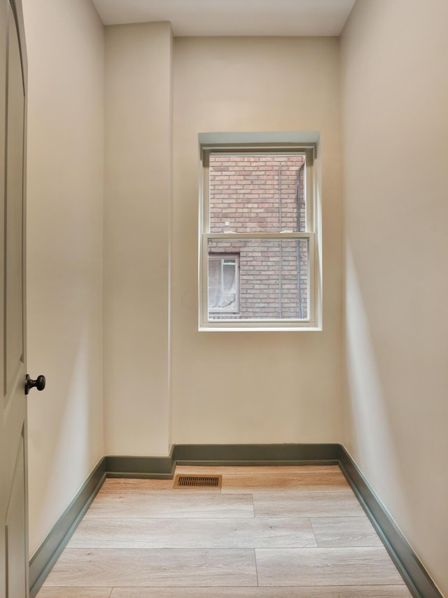 unfurnished room with light wood-type flooring