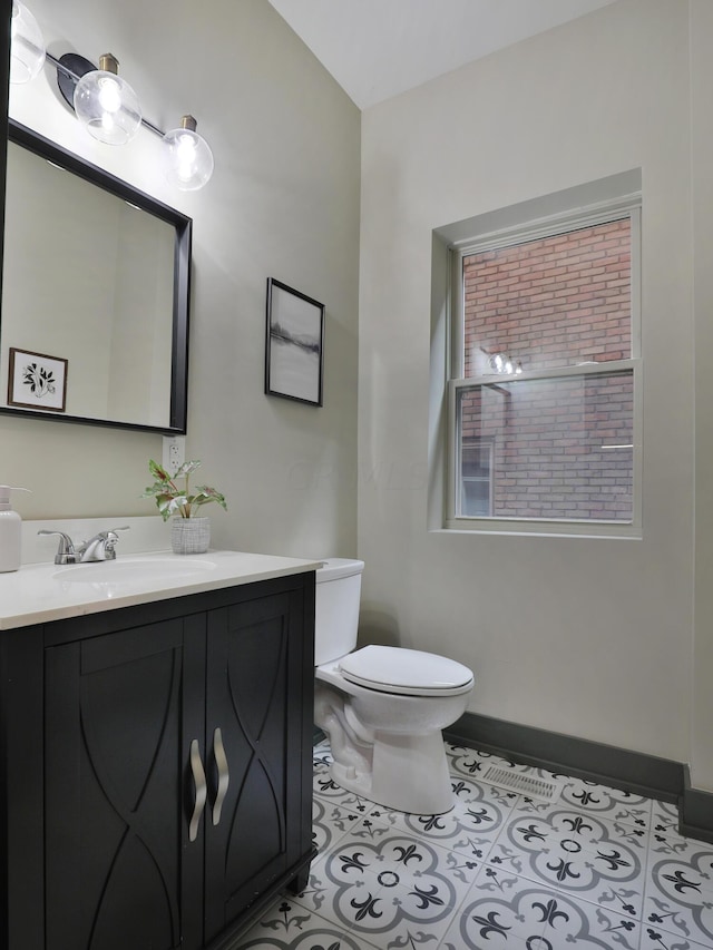 bathroom featuring tile patterned floors, vanity, and toilet