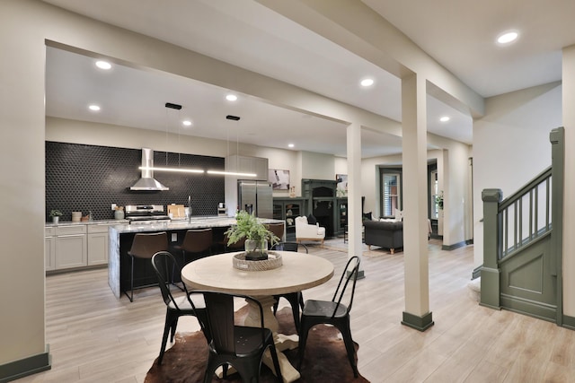 dining space with light wood-type flooring