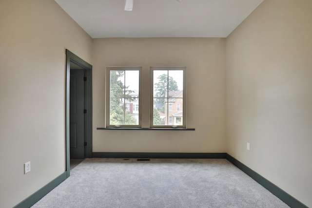 unfurnished room with light carpet