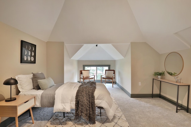 bedroom featuring light colored carpet and lofted ceiling