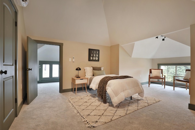 bedroom with light carpet and high vaulted ceiling