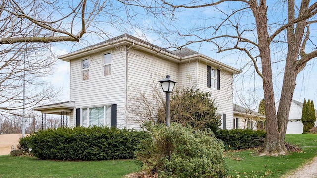 view of side of property with a lawn