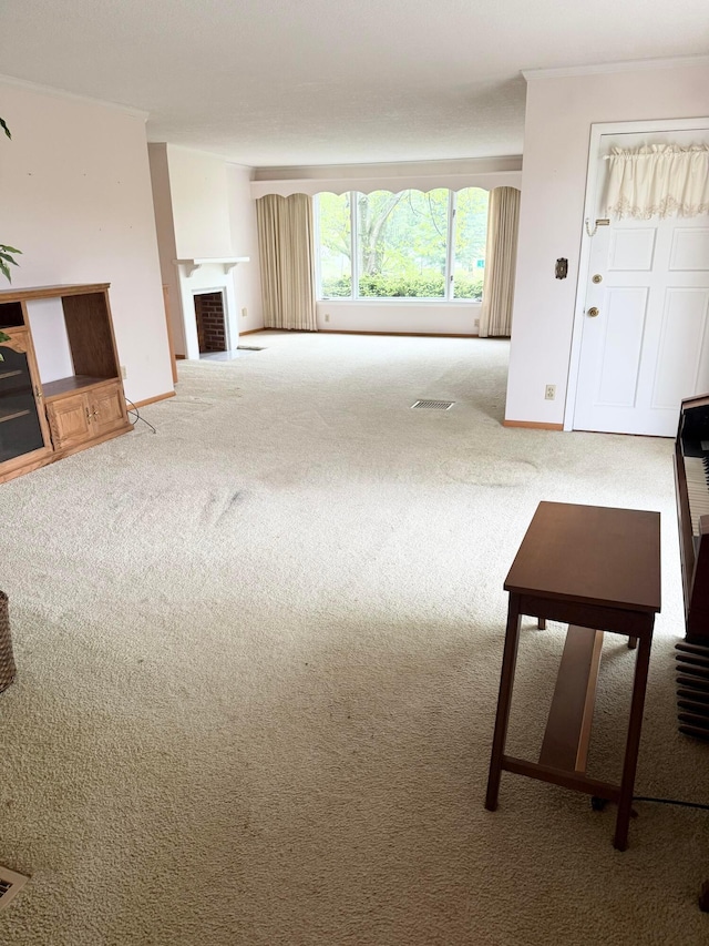 carpeted living area featuring baseboards, visible vents, and a fireplace