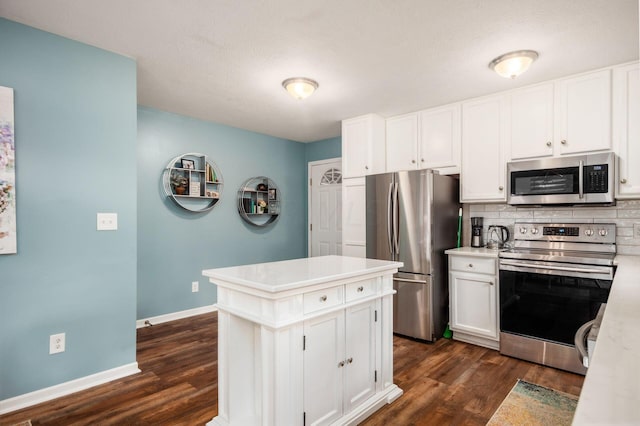 kitchen featuring dark hardwood / wood-style flooring, white cabinetry, and stainless steel appliances