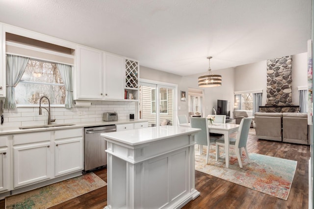 kitchen featuring dishwasher, hanging light fixtures, a healthy amount of sunlight, and sink