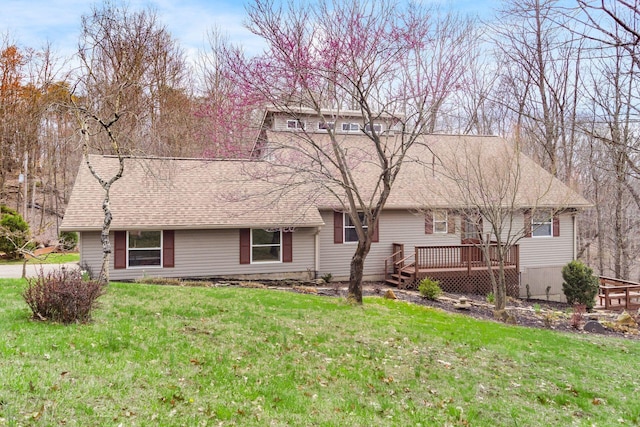 view of front facade with a wooden deck and a front lawn