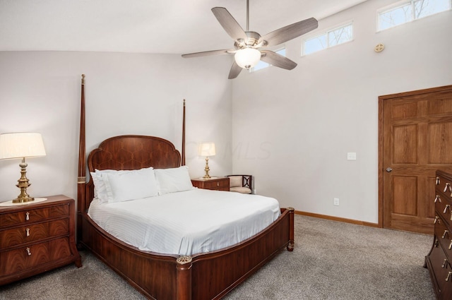 carpeted bedroom with ceiling fan and high vaulted ceiling