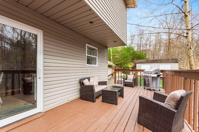 wooden deck featuring an outbuilding, outdoor lounge area, and grilling area