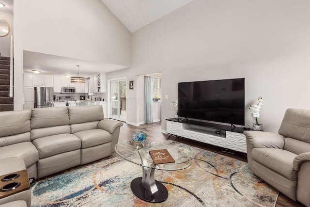 living room featuring hardwood / wood-style flooring and high vaulted ceiling