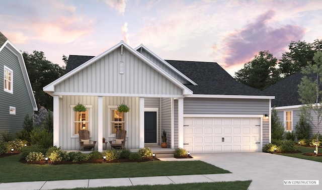 view of front of home with a yard and a garage