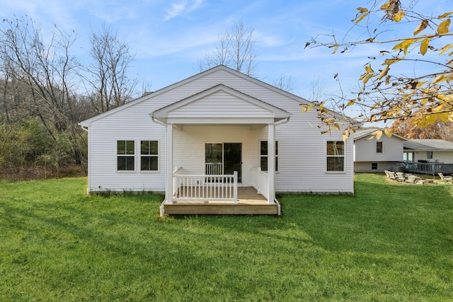 rear view of property featuring a yard