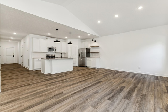 kitchen with dark hardwood / wood-style flooring, white cabinets, an island with sink, and appliances with stainless steel finishes