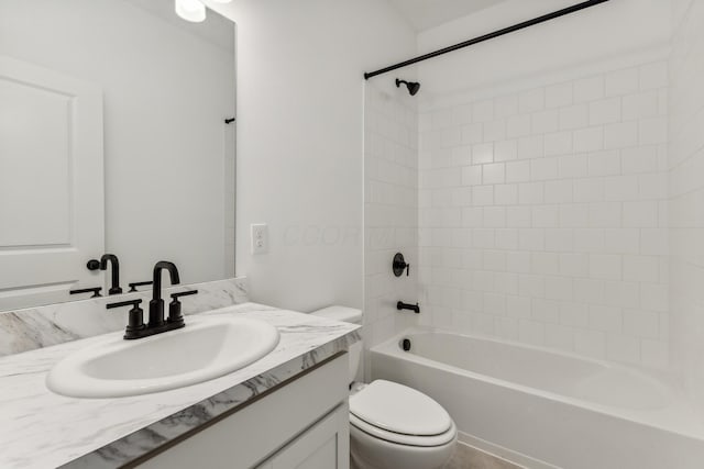 full bathroom featuring vanity, toilet, and tiled shower / bath