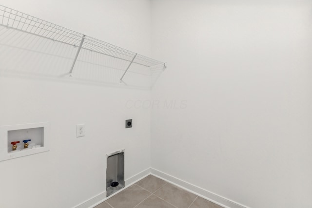 washroom featuring hookup for an electric dryer, washer hookup, and tile patterned flooring