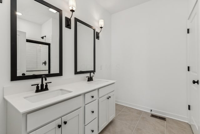 bathroom featuring tile patterned floors, vanity, and walk in shower