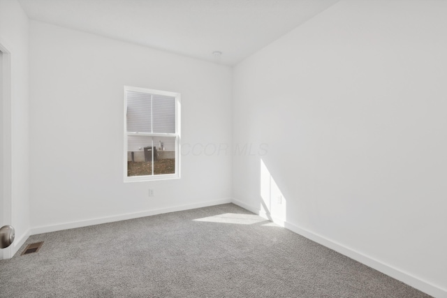 spare room featuring carpet