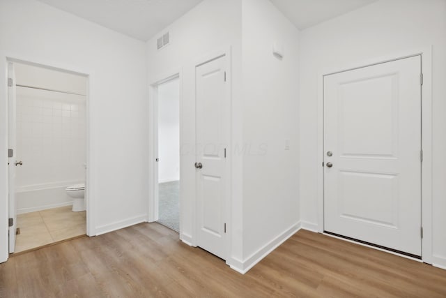 hallway with light hardwood / wood-style flooring