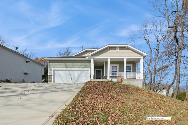 view of front of property with covered porch and a garage