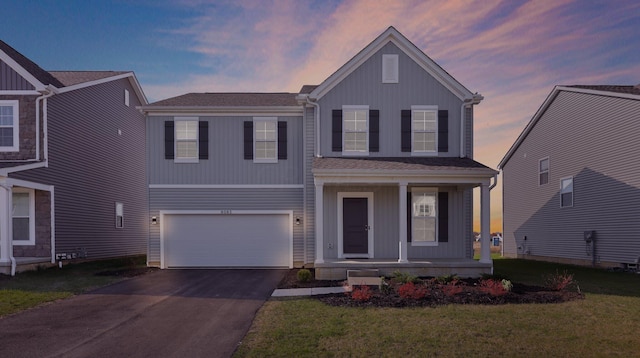 view of front of home featuring a yard and a garage