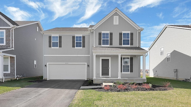 view of front of house with a front yard and a garage