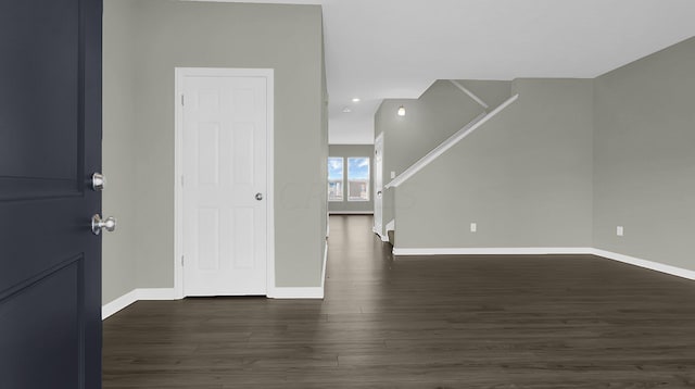 unfurnished room featuring dark wood-type flooring