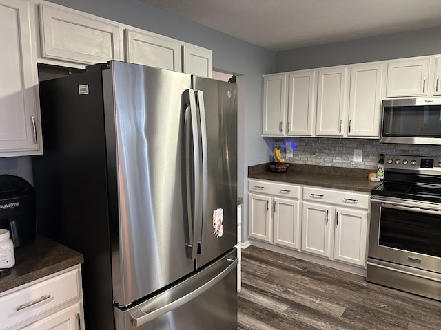 kitchen with backsplash, white cabinetry, stainless steel appliances, and dark hardwood / wood-style floors