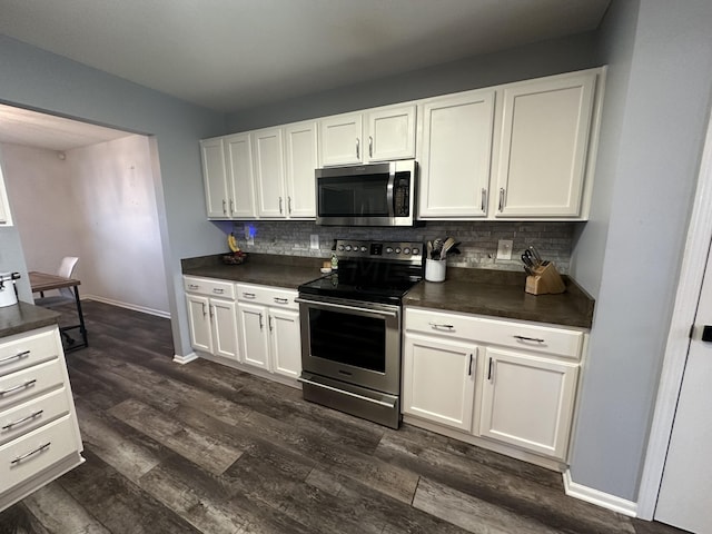 kitchen featuring dark hardwood / wood-style flooring, white cabinetry, stainless steel appliances, and tasteful backsplash