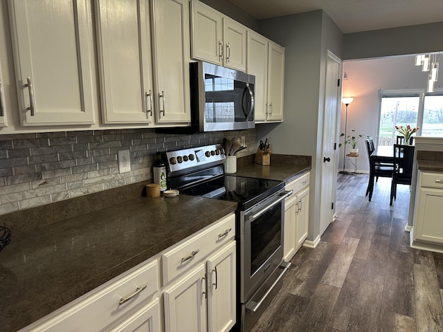 kitchen featuring white cabinets, decorative backsplash, dark hardwood / wood-style flooring, and stainless steel appliances