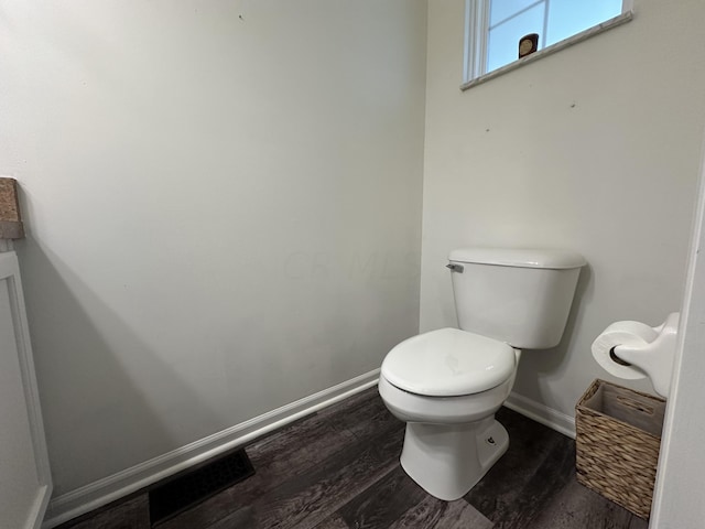 bathroom with wood-type flooring and toilet