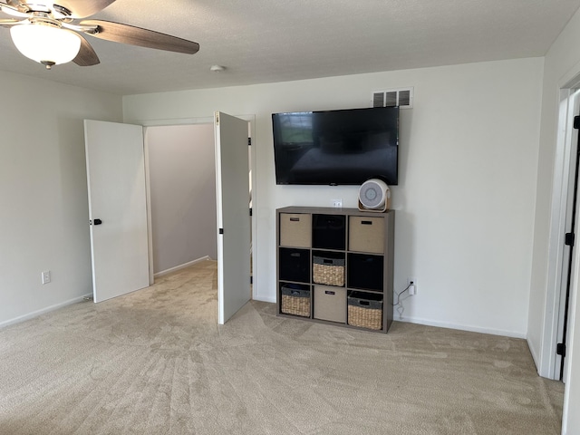 bedroom with ceiling fan and light carpet