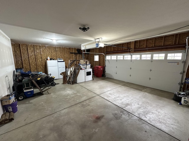 garage featuring white fridge and wooden walls