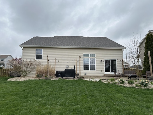 rear view of house featuring a yard and a patio